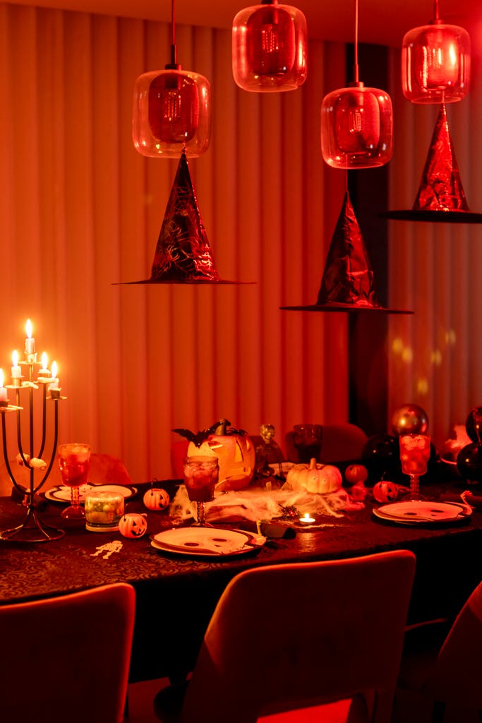 Captivating Halloween-themed table setup featuring candles, decorations, and a warm ambiance.